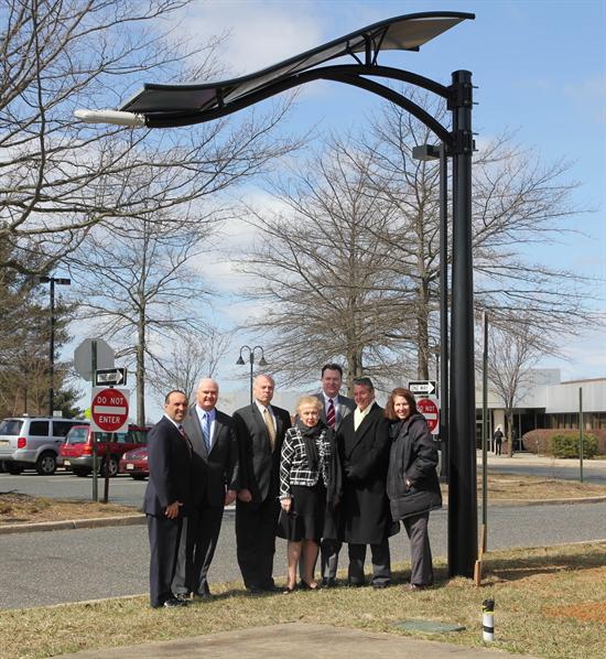 Freeholder Director Thomas A. Arnone, Freeholder John P. Curley, Freeholder Gary J. Rich, Sr., Freeholder Lillian G. Burry, Assemblyman Robert D. Clifton, Dr. Gerry Gorman, President & COO of LumiSolar and Assemblywoman Amy H. Handlin are pictured with the solar light pole at the Monmouth County Library Headquarters.